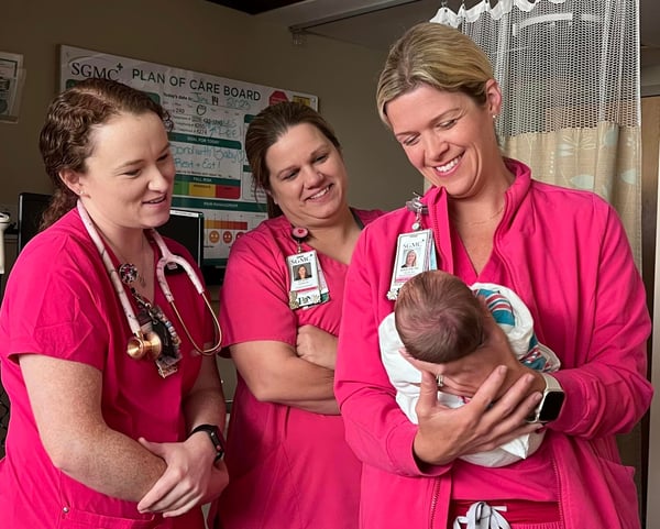 SGMC Nurses holding newborn