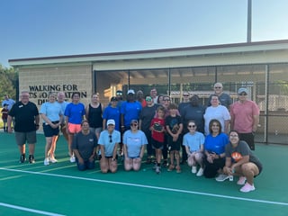 People kneeling on a tennis court