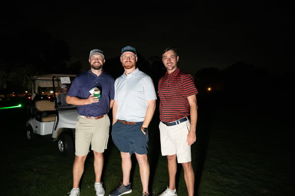 group of men playing golf at night