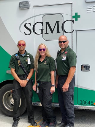 EMS professionals standing with ambulance