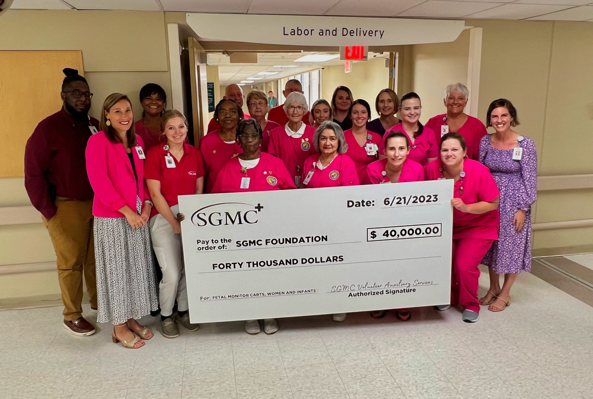 volunteers with giant cheque