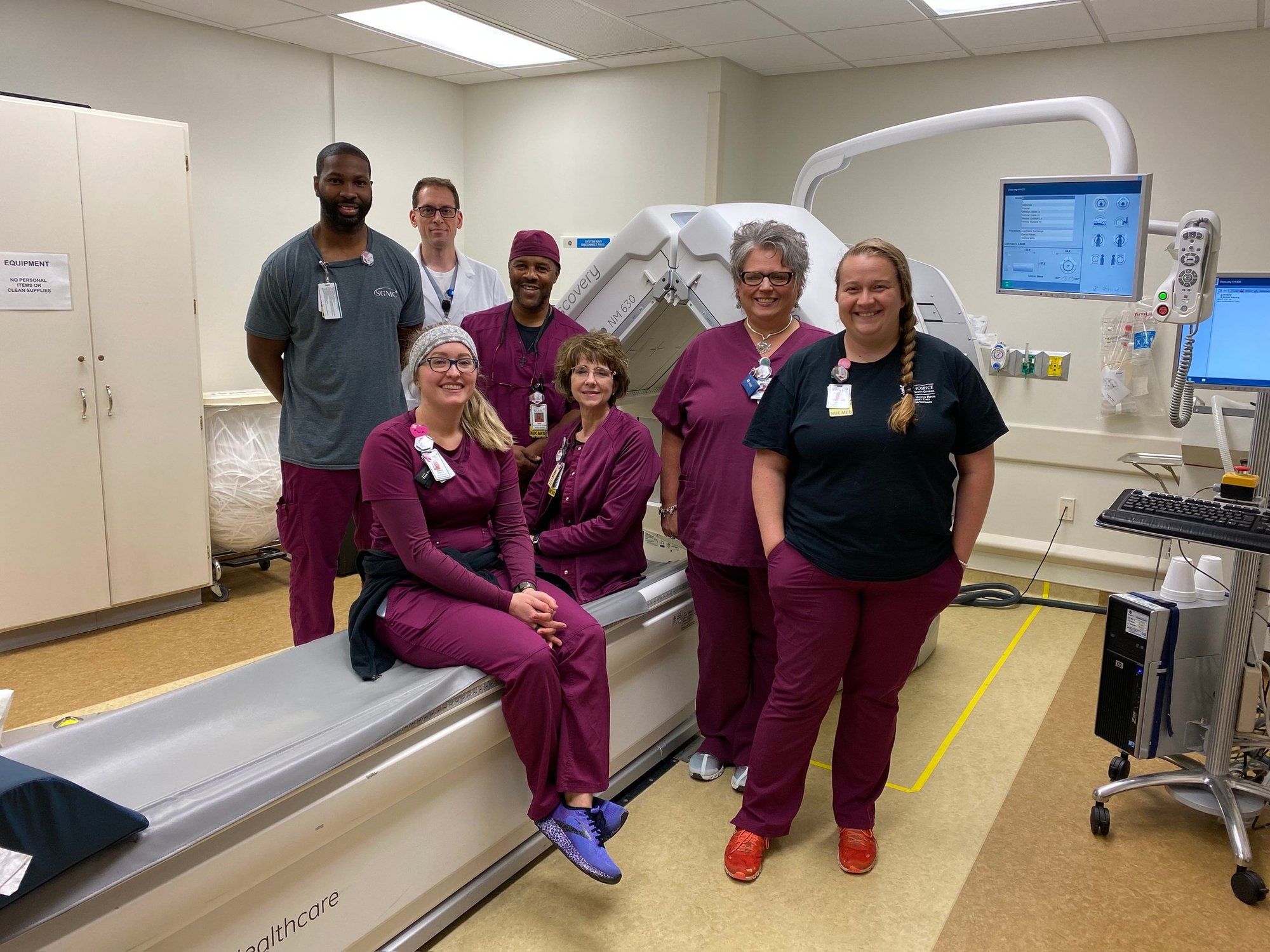 Group of radiology staff with MRI machine