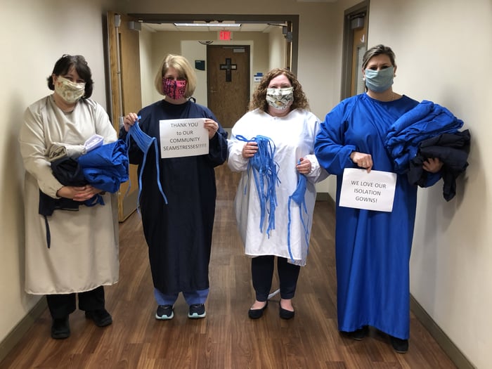 4 healthcare workers wearing PPE.