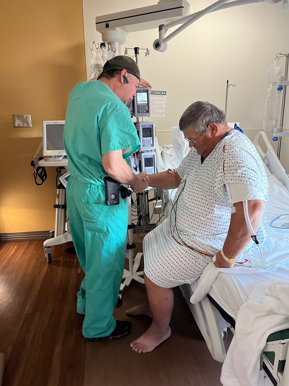 Dr. Johnson and Bubba praying before his procedure